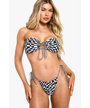 Striking checkerboard print bikini with eye-catching contrast pattern
        Bandeau-style top with centre tie detail for adjustable fit and support
        Side-tie bottoms allowing for customisable fit and comfort
        Strapless design perfect for minimising tan lines
        Brazilian cut bottoms for a flattering silhouette
    
    Make waves this season in our bold checkerboard print bikini. The bandeau top features a chic centre tie detail that adds a touch of retro charm whilst providing adjustable support. The Brazilian cut bottoms with side ties create a flattering look that can be adjusted to your comfort level. This striking two-piece is perfect for beach days, poolside lounging, or summer festivals. Pair with oversized sunglasses and a lightweight kimono for trips to the beach bar, or style with high-waisted denim shorts and sandals for casual coastal walks. The versatile design works brilliantly for active beach days or relaxed sunbathing sessions. This Boohoo bikini combines contemporary style with practical design elements, ensuring you'll stand out for all the right reasons on your next holiday adventure.