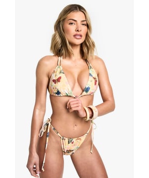 Striking cut-out triangle bikini featuring an eye-catching abstract butterfly print
        Flattering halterneck design with adjustable tie fastening for a customised fit
        Side-tie bikini bottoms with cut-out detail for added style and adjustability
        Lightweight swim fabric that dries quickly for all-day beach comfort
        Versatile two-piece design perfect for mixing and matching with other swimwear
    
    Make a statement poolside with this bold cut-out bikini from Boohoo. The distinctive abstract butterfly print captures attention whilst the flattering halterneck silhouette enhances your natural shape. The clever cut-out detailing adds a contemporary twist to this classic triangle style, whilst the adjustable ties at the neck and sides allow for a perfect fit. Style with oversized sunglasses and a loose linen shirt for casual beach bar visits, or pair with a matching sarong and metallic sandals when transitioning from sunbathing to seaside lunch. This bikini is ideal for those sun-soaked holidays where you want to stand out from the crowd - perfect for everything from lounging by the pool to beach volleyball with friends. Complete your look with stacked bangles and delicate layered necklaces for the ultimate summer ensemble.