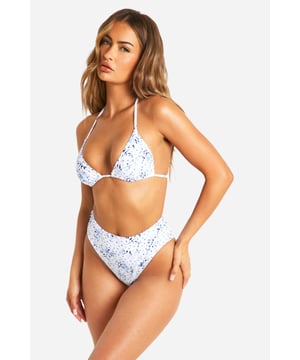 Triangle bikini top with adjustable strappy neck ties for a customised fit
        High-waisted bottoms with flattering cut to enhance your silhouette
        Distinctive porcelain-inspired print pattern for a standout beach look
        Secure tie fastening at the back ensures comfort throughout the day
        Versatile two-piece design perfect for mixing and matching with other swimwear
    
    Make a splash this summer with this eye-catching triangle bikini featuring a striking porcelain print. The classic triangle top offers adjustable coverage whilst the high-waisted bottoms create a figure-flattering silhouette that's both on-trend and comfortable for all-day wear. Perfect for those sun-soaked beach days or lounging by the pool on your next getaway. Style with oversized sunglasses and a lightweight kimono for trips to the beach bar, or pair with denim cut-offs and sandals when heading for coastal walks. For a complete holiday look, add a wide-brimmed straw hat and delicate anklet. This Boohoo bikini transitions effortlessly from daytime sunbathing to sunset beach parties, making it an essential addition to your holiday wardrobe.