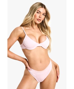 Delicate broderie anglaise detailing adds a feminine touch to this classic bikini
        Underwired cups provide excellent support and shape enhancement
        Adjustable shoulder straps ensure a comfortable, personalised fit
        Sleek, minimal design with clean lines for a contemporary poolside look
        Mid-rise bikini bottoms offer flattering coverage with a modern silhouette
    
    Make a statement at your next holiday destination with this eye-catching broderie bikini from Boohoo. The textured broderie fabric adds dimension and interest to this two-piece swimwear, whilst the underwired cups provide fantastic support for all-day comfort by the pool or sea. The adjustable straps allow you to customise the fit to your body shape, making this bikini both practical and stylish. Perfect for beach days, pool parties or simply lounging in the sun, this bikini can be paired with an oversized linen shirt and straw hat for a chic cover-up option when heading to the beach bar. For evening drinks by the water, throw on a sheer maxi skirt and add some delicate jewellery to transition effortlessly from day to night whilst maintaining that carefree holiday vibe.