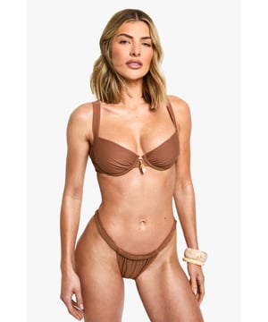 Underwired bikini top for enhanced support
        Distinctive shell-inspired trim detail
        Adjustable shoulder straps for a customised fit
        Decorative centre front shell charm
        Matching high-leg bikini bottoms available
    
    Make waves this summer with our eye-catching bikini top, perfect for the fashion-forward beach-goer. The underwired design offers ample support, while the unique shell-inspired trim adds a touch of coastal charm. Pair with the matching high-leg bottoms for a coordinated look that's sure to turn heads poolside or at the beach. For a chic cover-up, throw on a sheer kaftan and slip into some metallic sandals. Whether you're lounging by the pool or taking a dip in the sea, this versatile bikini top is your go-to for sun-soaked days and balmy evenings. Accessorise with oversized sunglasses and a wide-brimmed hat for ultimate holiday glamour.