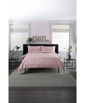 The Crossley Heath Duvet Set is crafted from 100% pure cotton for a naturally soft and breathable feel, featuring a timeless grid print complemented by piped cuffs and mock horn button detailing for a refined finish. With a 144 thread count, it offers the perfect balance of durability and comfort, making it ideal for everyday use and all-season appeal.