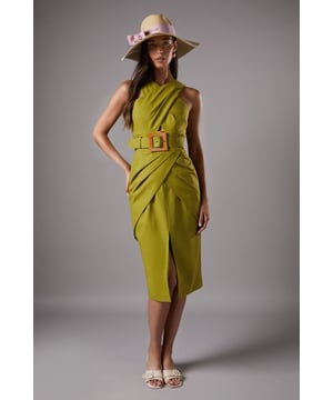 Distinctive cross-neck design creates an elegant silhouette
        Statement square buckle belt detail accentuates the waist
        Sophisticated side split adds movement and allure
        Linen-blend fabric offers breathable comfort with structure
        Midi length provides versatile styling options for various occasions
    
    The Lisa Polo Cross Neck Belted Dress from Coast embodies refined elegance with its architectural neckline and striking belt detail. The cross-neck design frames the dcolletage beautifully, while the structured silhouette with a side split creates a graceful movement as you walk. Perfect for summer race days or garden weddings, this dress commands attention without overwhelming. Style with a wide-brimmed hat and delicate strappy sandals as shown for a quintessentially British summer event look. For evening soires, swap the hat for statement earrings and add metallic heeled sandals. The versatile midi length works wonderfully for both daytime formality and evening sophistication, making this a standout piece for your occasion wardrobe that transitions effortlessly from day to night.