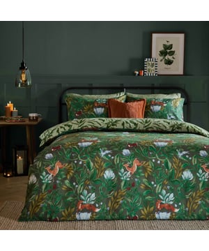 Turn your bedroom into a cosy woodland retreat with the Into The Woods Duvet Cover Set. Made from a durable cotton blend, this duvet features a charming, storybook-inspired design with woodland animals like foxes, hares, deer, and even a bright blue rabbit, all surrounded by lush foliage. The mix of earthy tones and floral accents gives off magical forest vibes, while the reversible side offers a simple leaf pattern for a more laid-back look. Built for comfort and style, this duvet set brings a rustic, relaxed feel to your space, perfect for creating your own little escape at home.