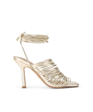 This KG Kurt Geiger Selected heel is crafted in a chic gold with multiple spagetti straps across the upper. There is a statement wrap strap fastening around the ankle. Heel height: 9cm.