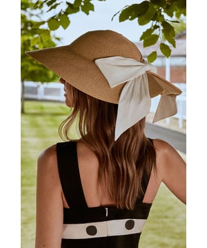 Classic round boater silhouette with a wide, structured brim for optimal sun protection
        Elegant bow detail adds a feminine touch to this timeless design
        Crafted from natural straw material with intricate weaving for texture and visual interest
        Lightweight construction ensures comfort throughout day-long events
        Versatile accessory that complements both formal occasion wear and refined daytime ensembles
    
    The Lisa Tan Round Straw Boater Hat exemplifies sophisticated British summer style. Perfect for race day events, garden parties, or summer weddings, this hat delivers the finishing touch to any occasion ensemble. Style with a tailored dress in a solid hue as shown by our model, allowing the hat to take centre stage. The structured silhouette and graceful bow detail create a refined aesthetic that works beautifully with both flowing maxi dresses and sharply cut jumpsuits. For a coordinated look, match your clutch or shoes to the bow's tone. This Coast creation is designed to make a statement whilst maintaining an air of understated elegance-ideal for the discerning woman who appreciates thoughtful details and classic design that transcends seasonal trends.