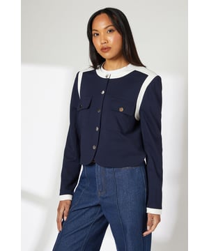 Cropped silhouette with a contemporary round neckline for a refined daywear look
        Striking contrast trim detailing along the neckline, shoulders and cuffs for distinctive visual appeal
        Practical front pockets with flap detail, adding both functionality and design interest
        Secure button-through front fastening with stylish metallic buttons
        Regular fit design offering comfortable movement whilst maintaining a smart silhouette
    
    This Principles cropped jacket masterfully blends practicality with polished style. The contrast trim creates a striking visual frame that draws attention to the structured silhouette, whilst the functional front pockets add practical detail to this versatile piece. Style with wide-leg trousers as shown for a contemporary take on workwear, or pair with tailored denim and ballet flats for weekend brunches. The cropped length works beautifully with high-waisted bottoms, creating a balanced proportion that flatters the waistline. For casual family gatherings, layer over a simple t-shirt with relaxed trousers, or dress up with a silk camisole and statement earrings for dinner dates. This jacket offers year-round versatility - wear alone during milder days or layer over fine knitwear when the temperature drops.