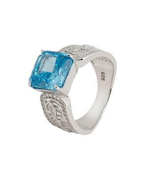 Immerse yourself in the elegance of the Rowena Cocktail Ring, an exquisite creation fashioned from the finest 925 sterling silver. The band is a work of art, featuring intricate open fretwork adorned with dazzling zircon, blending sophistication with a lightweight feel that promises all-day comfort.At the heart of this masterpiece lies a breathtaking lab-grown Blue Topaz, measuring 1.0cm x 1.0cm. Revered for its vivid blue brilliance, Blue Topaz is the birthstone for December, symbolizing love and fidelity. Its captivating hue evokes the serene beauty of a clear winter sky, making it a perfect gemstone for any occasion.Weighing a mere 7.1 grams, the Rowena Cocktail Ring marries luxury with effortless wearability. Available in four sizes, it guarantees a flawless fit for every hand. Elevate your jewellery collection with the Rowena Cocktail Ring and let the radiant blue splendour of Blue Topaz illuminate your fingers. This exquisite piece adds a touch of timeless elegance and refined charm to any ensemble, making it an indispensable addition to your collection.