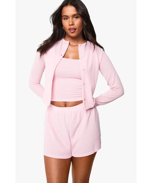 Soft ribbed texture for ultimate comfort and tactile appeal
        Button-through front design for versatile styling options
        Cropped length perfect for layering with coordinating pieces
        Long sleeves for year-round wearability
        Part of a mix and match loungewear collection for creating personalised sets
    
    This ribbed cardigan from Boohoo's loungewear collection offers the perfect balance of comfort and style for your relaxed moments. The cropped silhouette pairs beautifully with the matching shorts as shown, creating a coordinated look that's both put-together and effortlessly casual. Style with a simple crop top underneath for layering flexibility, or wear buttoned up as a standalone top. For those cooler evenings at home, complement with soft joggers and fluffy socks, or dress it up slightly with leggings and trainers for quick errands. The versatile design transitions seamlessly from morning coffee to evening relaxation, making it an essential addition to your loungewear rotation. Pair with gold-toned minimal jewellery for a touch of elegance even on your most laid-back days.