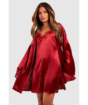 Luxurious satin finish that catches the light beautifully for a glamorous bedtime look
        Dramatic flare sleeves that add a touch of elegance to your nightwear collection
        Adjustable tie waist belt for a customised fit that flatters your silhouette
        V-neckline design that creates a feminine and flattering frame
        Mid-thigh length offering comfortable coverage whilst maintaining a stylish aesthetic
    
    Transform your nightwear collection with this stunning satin robe from Boohoo. The sumptuous fabric glides against the skin for ultimate comfort, whilst the statement flare sleeves add a touch of drama to your evening routine. The adjustable tie waist allows you to create the perfect silhouette, whether worn loosely or cinched in. This versatile piece works brilliantly as part of a coordinated set with a matching slip or cami and shorts, or simply on its own for those warmer evenings. Perfect for lounging at home or packing for a weekend getaway, this robe combines practicality with style. The fluid drape of the fabric creates an effortlessly chic look that will make bedtime feel like a luxury experience every night.
