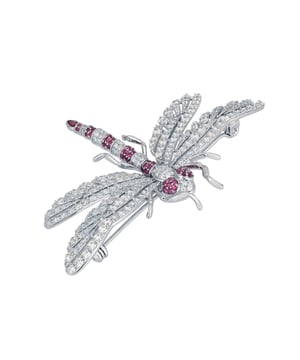 The Dragonfly Brooch is a masterfully crafted piece made from high-quality 925 sterling silver. This exquisite brooch captures the delicate beauty of a dragonfly, adorned with a dazzling array of ruby pink and white zirconia. The body of the dragonfly features alternating stripes of pink and white, along with pink eyes, creating a stunning visual contrast that is sure to catch the eye.The wings are intricately designed with a lace-like pattern, encrusted with sparkling white zirconia that shimmer with every movement. The tail of the dragonfly is elegantly finished with a larger ruby-coloured zirconia, making this brooch a true statement piece. Measuring 7.0cm in width, 5.0cm in length, and weighing a comfortable 12.7 grams, this brooch is perfect for adding a touch of glamour to any outfit.Dragonflies hold a special place in jewellery, symbolizing transformation, adaptability, and a deep connection to nature. They remind us to embrace change and live life to the fullest, making this brooch not just a beautiful accessory but a meaningful piece of art.Perfect for nature enthusiasts, lovers of fine craftsmanship, and anyone who appreciates unique and symbolic jewellery. Add the Dragonfly Brooch Silver Ruby Cz to your collection today and let its beauty and symbolism inspire you.