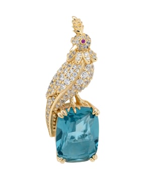 Your brooch is a statement of elegance, inspired by the quiet majesty of nature. Designed in the image of a regal crested bird, this handcrafted piece is forged in 925 sterling silver and richly plated with 18ct gold for a luxurious finish that gleams with timeless beauty.Nestled beneath the zirconia-encrusted bird, a lab-created London blue topaz—cut to a refined rectangular silhouette—adds a deep, oceanic sparkle that captivates in every light. At 3.8 cm long, 1.4cm wide and just 7.0 grams in weight, your brooch wears with comfortable grace on any lapel, scarf, or dress.Whether you're accenting a formal look or adding a touch of opulence to your everyday style, your brooch offers a wearable blend of art, craftsmanship, and storytelling. This is more than an accessory—it’s a piece that speaks.