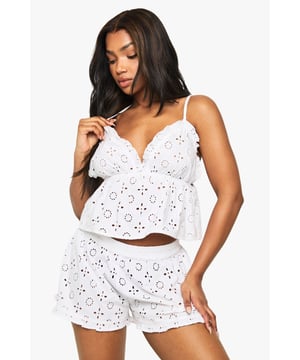 Delicate broderie anglaise pattern throughout for a feminine touch
        Flattering cropped cami top with adjustable spaghetti straps
        Ruffle trim detailing along the hem of both top and shorts
        Elasticated waistband on shorts for comfortable all-night wear
        Relaxed fit shorts with scalloped ruffle edges
    
    Drift into dreamland in style with this charming broderie anglaise pyjama set from Boohoo. The intricate eyelet pattern adds a touch of romance to your nightwear collection, whilst the cropped cami silhouette with delicate straps offers a contemporary twist on classic sleepwear. The matching shorts feature a comfortable elasticated waist and playful ruffle trim, ensuring both comfort and style as you unwind. Perfect for warm summer evenings or for lounging on lazy weekend mornings with a cup of tea and your favourite book. This set strikes the ideal balance between comfort and femininity - pair with fluffy slippers and a lightweight dressing gown for those midnight kitchen trips.