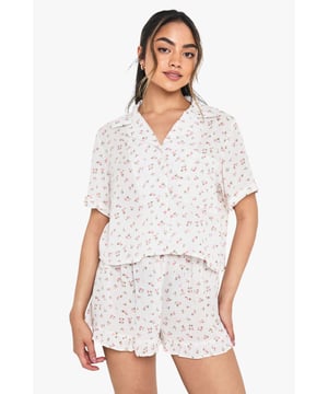 Charming floral print short pyjama set with classic collared shirt design
        Relaxed boxy fit shirt with short sleeves for ultimate comfort
        V-neck collar adds a touch of sophistication to your nightwear collection
        Matching shorts with gentle elastic waistband for a comfortable fit
        Lightweight woven fabric perfect for year-round wear
    
    Drift into dreamland in style with this delightful floral pyjama set from boohoo. The boxy shirt silhouette offers a relaxed feel that doesn't compromise on style, whilst the matching shorts create a coordinated look that's both practical and pretty. Perfect for warm summer nights or cosy evenings with a dressing gown layered on top during cooler months. The versatile design makes this set ideal for lounging at home with friends during sleepovers or enjoying a lazy weekend morning with a cup of tea. Style with fluffy slippers and your favourite hair accessories, just as shown on our model, for the ultimate night-in ensemble that combines comfort with a touch of feminine charm.