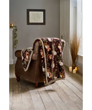 Escape to the heart of the forest with the Deyongs Woodland Wildlife Throw, available in Sage, Wine, and Navy. Each colourway features a beautifully detailed print of foxes, squirrels, owls, and foliage, capturing the serene magic of woodland life. The luxurious 220gsm flannel front offers a velvety-soft feel, while the 200gsm sherpa reverse wraps you in plush warmth—perfect for cosy evenings indoors. Measuring 140x180cm and made from 100% polyester, this throw is machine washable and ideal for adding rustic charm and comfort to your sofa, armchair, or bed.