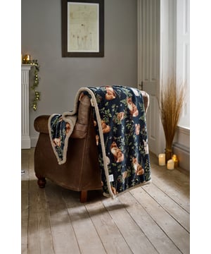 Escape to the heart of the forest with the Deyongs Woodland Wildlife Throw, available in Sage, Wine, and Navy. Each colourway features a beautifully detailed print of foxes, squirrels, owls, and foliage, capturing the serene magic of woodland life. The luxurious 220gsm flannel front offers a velvety-soft feel, while the 200gsm sherpa reverse wraps you in plush warmth—perfect for cosy evenings indoors. Measuring 140x180cm and made from 100% polyester, this throw is machine washable and ideal for adding rustic charm and comfort to your sofa, armchair, or bed.