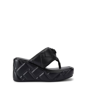 This Kensington Puff Wedge Sandal is crafted from a black leather with padded quilting detail across the T-bar upper. The sole is in a wedge style. Heel height: 9cm.
