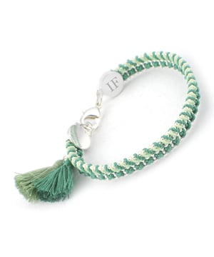 Santorini Bracelet by Ion Fiz: Handcrafted color with a designer stamp.\n\n Inspired by the freshness of the Mediterranean, this bracelet stands out for its combination of carefully interwoven textures and tones. The design blends nylon and cotton threads with a delicate zinc chain, creating a piece with a distinctive character and relaxed style.\n\n Details:\n - Hand-woven with nylon and cotton threads in various harmonious tones.\n - Lightweight zinc chain with shiny metallic finish.\n - Strong lobster clasp, easy to attach and secure.\n - Decorative textile tassel detail at the ends.\n - Metal pendant engraved with the firm's distinctive IF.\n\n A comfortable, creative, and distinctive bracelet, ideal for adding a distinctive and colorful touch to your everyday or seasonal looks.\n Measures: Diameter: 6 cm\n Composition: Nylon, Cotton, Zinc\n Care:\nAvoid contact with water, perfumes or abrasive products.