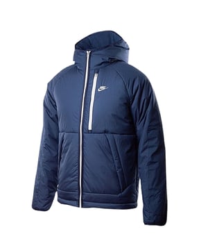 Stay warm and dry with the Nike Dark Blue Padded Jacket, crafted from 100% polyester with Therma-FIT technology to retain heat efficiently. This water-repellent jacket features a full zip fastening for easy wear, two front pockets secured with buttons, and a zippered left breast pocket for secure storage. The attached hood offers extra protection against the elements, while the iconic Nike badge on the left breast adds a stylish touch. Perfect for outdoor activities or casual wear, this jacket combines functionality and comfort in a sleek design