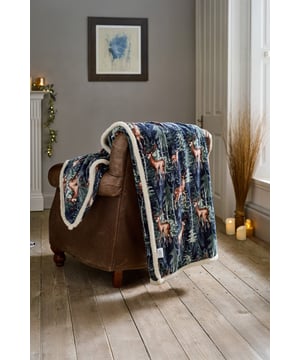 Add a touch of woodland charm and luxurious comfort to your home with the Deyongs Stag Sherpa Throw. Featuring a striking navy backdrop with a detailed stag and forest print, this generously sized 140x180cm throw is made from ultra-soft 220gsm flannel on the front and a cosy 200gsm sherpa fleece reverse. Perfect for snuggling on the sofa, layering over a bed, or enhancing your décor with a rustic winter look, it’s both stylish and practical, crafted from 100% polyester and machine washable for easy care.