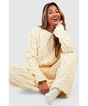 Cosy cable knit design for added texture and warmth
        Relaxed fit sweatshirt for ultimate comfort
        Soft fleece fabric for a luxurious feel
        Coordinating wide-leg trousers for a complete lounge set
        Versatile piece suitable for both indoor relaxation and casual outings
    
    Embrace laid-back luxury with this Cable Knit Fleece Lounge Sweatshirt from Boohoo. Perfect for those who crave comfort without compromising on style, this piece seamlessly blends cosiness with on-trend design. The intricate cable knit pattern adds a touch of sophistication to your loungewear collection, while the soft fleece fabric ensures you stay snug during relaxed evenings at home or casual weekend brunches. Pair with the matching wide-leg trousers for a coordinated look, or style with your favourite jeans for a quick coffee run. Add some fluffy socks and a steaming mug of tea for the ultimate night in, or throw on some trainers and a denim jacket for an effortlessly chic errand ensemble. This versatile sweatshirt is your go-to for all those moments when you want to feel comfortable yet put-together.