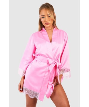 Luxurious satin fabric for a smooth, comfortable feel
        Elegant lace trim detailing on sleeves and hem
        Versatile wrap design with tie waist
        Three-quarter length sleeves for a graceful silhouette
        Perfect balance of coverage and allure
    
    Indulge in the ultimate nighttime luxury with this stunning satin lace trim robe. The smooth, lustrous fabric glides against your skin, whilst the delicate lace detailing adds a touch of romance and femininity. Whether you're preparing for bed or enjoying a lazy weekend morning, this robe offers both comfort and style. The wrap design allows for a customisable fit, cinching at the waist to flatter your figure. Pair with matching satin pyjamas for a coordinated bedtime ensemble, or wear over your favourite nightie for an extra layer of elegance. This versatile piece is ideal for those moments when you want to feel both relaxed and refined in your own home.