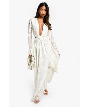 Striking textured chiffon fabric with intricate detailing
        Plunging V-neckline for a daring and alluring look
        Dramatic cut-out design at the waist adds a modern twist
        Flowing maxi length with a graceful silhouette
        Long, billowing sleeves create an ethereal effect
    
    Make a statement at your next night out with this show-stopping textured cut-out maxi dress. The chiffon fabric drapes beautifully, creating an enchanting silhouette that's perfect for dancing the night away. The plunging V-neckline and strategically placed cut-out detail at the waist offer a tantalising glimpse of skin, whilst the long, flowing sleeves add a touch of drama to your ensemble. Style this dress with strappy heels and a clutch bag for a head-turning look that's sure to turn heads at the club. For a more relaxed vibe, pair it with metallic sandals and statement earrings for drinks with friends. This versatile piece can easily transition from a glamorous evening event to a chic beachside soire, making it a must-have addition to your wardrobe.