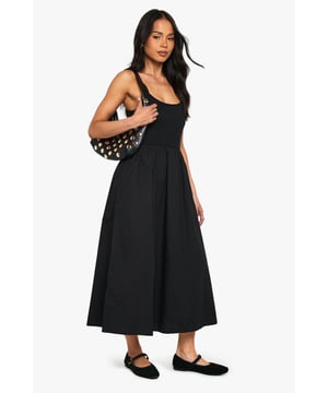 Flattering scoop neckline for a feminine touch
        Sleeveless design perfect for warmer days
        Fitted bodice with a flared skirt for a classic silhouette
        Midi length offers versatile styling options
        Soft cotton blend fabric ensures all-day comfort
    
    This charming jersey dress from Boohoo is the epitome of effortless style. The scoop neckline and sleeveless cut create a graceful look, while the fitted bodice smoothly transitions into a flared skirt, crafting a timeless silhouette. The midi length strikes the perfect balance between casual and chic, making it suitable for various occasions. Style it with flat sandals and a denim jacket for a relaxed daytime look, or dress it up with statement earrings and strappy heels for evening drinks. The versatile design allows for easy layering - throw on a cropped cardigan for cooler evenings or pair it with trainers for a trendy, laid-back vibe. This dress is a wardrobe essential that will take you from family gatherings to casual outings with friends, all while keeping you comfortable and stylish.