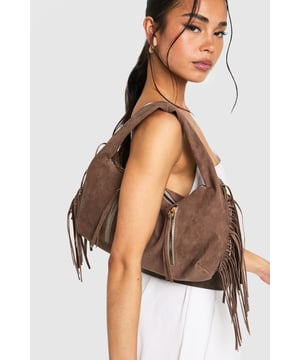 Faux suede hobo bag with statement fringe detailing along both sides
        Spacious main compartment with secure zip closure
        Twin decorative front zips with metallic pull tabs
        Comfortable curved top handle for easy carrying
        Soft-touch finish that mimics the luxurious feel of genuine suede
    
    This boho-inspired faux suede bag brings a touch of festival chic to your everyday wardrobe. The distinctive fringe detailing creates movement and texture, whilst the practical hobo silhouette offers ample space for your essentials. Style with white wide-leg trousers and a fitted top as shown for a balanced daytime look, or pair with a floaty midi dress and ankle boots for evening drinks. The versatile design transitions effortlessly from office to dinner date, making it the perfect companion for your busy social calendar. The curved handle sits comfortably on your shoulder, whilst the secure zip closure keeps your belongings safe. This Boohoo bag combines practicality with on-trend styling, perfect for the fashion-forward woman who values both form and function.