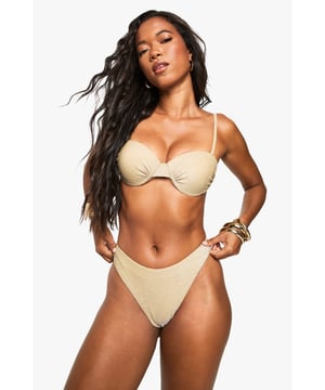 Sparkling glitter finish that catches the light beautifully
        Underwired cups for enhanced support and shape
        Adjustable shoulder straps for a customised fit
        High-leg briefs for a flattering silhouette
        Clasp fastening at the back for secure wear
    
    Make a dazzling statement poolside with this eye-catching Glitzer Bgel-Bikini from Boohoo. The underwired design offers fantastic support whilst the glittering fabric ensures you'll shine from sunbathing to sunset cocktails. Style with oversized sunglasses and stacked gold bangles as shown for maximum impact, or pair with a sheer cover-up when heading from beach to bar. The high-leg briefs elongate your silhouette, whilst the classic two-piece design allows for mixing and matching with other swimwear pieces in your holiday collection. Perfect for those summer getaways where you want to turn heads, this bikini combines practicality with party-ready glamour - ideal for everything from lounging by the pool to beach club socials.