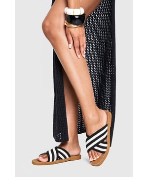 Distinctive crochet cross-over straps with bold stripe pattern
        Comfortable flat design with heel height between 0-2cm
        Cushioned footbed with contrast stitching detail
        Durable non-slip sole perfect for everyday wear
        Easy slip-on style for effortless summer dressing
    
    These crochet cross-over sandals bring a touch of artisanal charm to your summer wardrobe. The textured crochet finish creates visual interest while the contrasting stripe pattern adds a contemporary twist to a classic silhouette. Style them with a flowing maxi dress for a relaxed beach day, or pair with cropped trousers and a linen shirt for casual weekend brunches. The flat design ensures all-day comfort whether you're strolling through city streets or enjoying a coastal getaway. For festival season, match with denim shorts and a graphic tee, or dress them up with a breezy midi skirt for garden parties. Their versatility makes them an essential addition to your holiday packing list - perfect for transitioning from poolside lounging to impromptu evening walks along the promenade.