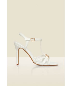 The answer to every accessorising dilemma Set on a sexy stiletto heel Ankle and t-bar strap for a supportive fit Elevated with a luxe gold snaffle detail White = endless styling options Dress up jeans and a nice top or style with a special occasion dress