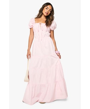 Charming square neckline with delicate tie-front detail
        Feminine puff sleeves for a romantic silhouette
        Tiered maxi design creates beautiful movement and volume
        Cotton poplin fabric offers breathable comfort for all-day wear
        Flattering empire waistline that enhances your natural shape
    
    This cotton poplin tiered maxi dress from Boohoo combines effortless style with day-long comfort. The dreamy silhouette features a square neckline and sweet puff sleeves that capture a romantic aesthetic perfect for summer days. Style with flat sandals and a woven tote for farmers' markets and brunch dates, or dress it up with espadrille wedges and statement earrings for garden parties and casual gatherings. The tiered design creates beautiful movement as you walk, while the breathable fabric keeps you cool during warmer weather. This versatile piece transitions seamlessly from daytime casual to evening relaxed events - simply switch your accessories to customise your look. Pair with a denim jacket for cooler evenings or wear alone to showcase the dress's beautiful structure and flow.