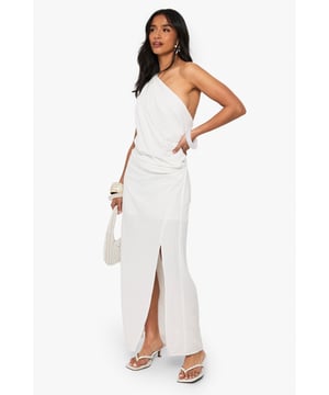 Striking one-shoulder design with elegant draping detail
        Flowing maxi length with side split for effortless movement
        Dramatic open back feature adds a sultry touch
        Linen-look fabric offers a lightweight, textured finish
        Petite fit designed specifically for smaller frames
    
    This captivating draped maxi dress combines Grecian-inspired elegance with contemporary flair. The asymmetric one-shoulder neckline creates a striking silhouette, while the flowing fabric cascades beautifully to the floor with a side split that allows for graceful movement. Perfect for evening soires, pair with strappy heels and statement bangles as shown for a sophisticated nightlife look. The open back detail adds an unexpected twist to this otherwise classic design. Versatile enough for upscale cocktail events or summer parties, this dress can be styled with metallic accessories for glamorous occasions or dressed down with flat sandals for more casual gatherings. The linen-look texture adds dimension and interest to this Boohoo showstopper that's sure to turn heads on your next night out.