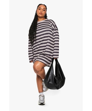 Relaxed oversize fit with dropped shoulders for effortless comfort
        Classic horizontal stripe pattern throughout for timeless appeal
        Versatile T-shirt dress design with a mini-length cut
        Soft jersey fabric that drapes beautifully on the body
        Long sleeves for additional coverage and transitional season wear
    
    This striped T-shirt dress from Boohoo's Plus collection embodies casual chic with its relaxed silhouette and contemporary stripe pattern. The oversize design creates a laid-back vibe that's perfect for your off-duty wardrobe. Style it as seen with chunky trainers and a statement handbag for running errands or weekend brunches. For cooler days, layer with opaque tights and a denim jacket, or add a leather belt to define your waist. The versatile nature of this dress makes it ideal for family gatherings, coffee dates, or casual shopping trips. The jersey fabric ensures all-day comfort while maintaining a fashionable edge. This T-shirt dress is the ultimate throw-on-and-go piece that doesn't compromise on style - a true wardrobe essential for the fashion-forward woman who values both comfort and trend-led design.