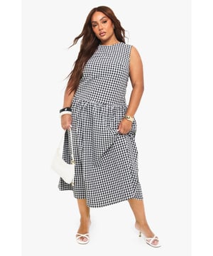 Textured gingham midi dress with a flattering smocked design
        Sleeveless silhouette with a modest round neckline
        Practical side pockets for everyday convenience
        Gathered skirt detail creates a feminine, flowing shape
        Versatile midi length perfect for various seasonal styling
    
    This charming gingham midi dress combines timeless pattern with contemporary design. The smocked detailing creates a flattering silhouette that gently defines the waist before flowing into a beautifully gathered skirt. Style with white kitten heels and a small handbag for family gatherings or weekend brunches. For cooler days, layer with a cropped denim jacket and trainers for an effortlessly casual look. The practical side pockets add functionality to fashion, while the versatile midi length works beautifully across seasons. Perfect for garden parties, casual outings or relaxed office environments, this Boohoo dress offers the ideal balance of comfort and style for the fashion-forward woman who values both trend and wearability.