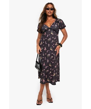 Textured midaxi dress with flattering empire waistline
        Feminine V-neckline with subtle gathering detail
        Short puff sleeves with delicate ruffle trim
        Practical side pockets for everyday convenience
        Flowing A-line silhouette that skims the body beautifully
    
    This charming patterned midaxi dress from Boohoo combines comfort with effortless style for your casual wardrobe. The textured fabric adds dimension while the empire waistline creates a flattering silhouette that works for various body types. Style with minimal flat sandals as shown for daytime gatherings, or switch to chunky trainers and a denim jacket for weekend brunches. The versatile length makes it perfect for family occasions or garden parties - simply add statement jewellery and a structured handbag to refresh the look. For cooler days, layer with a lightweight cardigan and ankle boots. The practical side pockets add functionality to this feminine piece, making it a go-to option that transitions seamlessly from casual meetups to relaxed evening events.