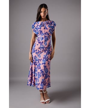 Captivating floral chiffon midi dress
        Elegant cap sleeves with subtle gathering
        Flattering round neckline
        Alluring side slit for ease of movement
        Flowing silhouette with a graceful midi length
    
    Embrace sophistication with this stunning chiffon midi dress from Coast. Perfect for those special occasions that demand a touch of elegance, this dress radiates charm with its eye-catching floral pattern. The cap sleeves offer a graceful frame to the shoulders, while the round neckline keeps the look refined and timeless. A daring side slit adds a contemporary twist, allowing for ease of movement whether you're attending a wedding or sipping champagne at the races. Style this versatile piece with strappy heels and a clutch for a polished ensemble. For cooler evenings, drape a lightweight pashmina over your shoulders. This dress is not just an outfit; it's a statement of grace and femininity, ideal for the woman who appreciates quality and wants to look effortlessly chic at any formal event.