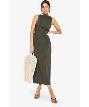 Sleeveless midi dress with elegant racer neckline for a contemporary silhouette
        Flattering ruched detailing across the bodice creates visual interest and texture
        Bengaline fabric offers a structured yet comfortable fit that maintains its shape throughout wear
        Tall fit designed specifically for longer frames, ensuring perfect proportions
        Versatile midi length hits below the knee for a sophisticated casual look
    
    This sleeveless midi dress combines effortless style with day-to-night versatility. The racer neckline creates a modern, athletic-inspired silhouette, while the ruched detailing adds dimension and flatters your natural curves. Perfect for casual occasions, style with minimal strappy sandals and a woven tote bag as shown for daytime gatherings. For family events, pair with delicate gold jewellery and ballet flats for an understated elegant look. The structured Bengaline fabric ensures the dress maintains its shape whilst offering comfort for all-day wear. The midi length works beautifully for various settings, from garden parties to informal dinners. This Boohoo piece embodies the brand's commitment to inclusive fashion that doesn't compromise on trend-forward design, making it a wardrobe staple for the fashion-conscious woman.