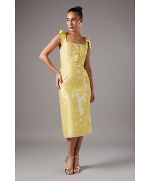 Elegant jacquard fabric with intricate pattern
        Square neckline with charming tie shoulder straps
        Button-through front detail
        Figure-flattering pencil silhouette
        Midi length with back vent for ease of movement
    
    Radiate sophistication in this stunning jacquard midi dress from Coast. The eye-catching pattern and luxurious texture of the fabric create a look that's both refined and fashion-forward. The square neckline and tie shoulder straps add a touch of feminine charm, while the button-through front detail offers a classic finish. The pencil silhouette beautifully contours your figure, making it an ideal choice for formal occasions that demand elegance. Perfect for weddings, the races, or any upscale event, this dress can be styled with strappy metallic heels and statement earrings for a polished ensemble. For cooler evenings, drape a lightweight pashmina over your shoulders. The versatile design allows for easy transition from day to night, ensuring you'll stand out with grace at any sophisticated gathering.