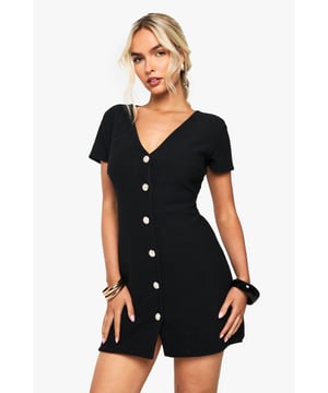 Flattering V-neckline design with short sleeves for effortless style
        Distinctive gold-tone button detailing down the front creates visual interest
        Figure-enhancing ribbed fabric that contours to your silhouette
        Versatile mini length perfect for showcasing your favourite footwear
        Structured yet comfortable fit that maintains its shape throughout the night
    
    Make a statement on your next night out with this chic button-through dress from Boohoo. The ribbed texture adds dimension whilst the V-neckline frames your dcolletage beautifully. Style with strappy heels and statement jewellery as seen on our model for a complete look that transitions seamlessly from drinks to dancing. The gold-tone buttons add a touch of glamour to this otherwise minimalist piece. For cooler evenings, layer with a cropped jacket and accessorise with a compact handbag. This versatile dress works brilliantly for impromptu drinks with friends or planned nights at the club - simply customise your accessories to suit the occasion.