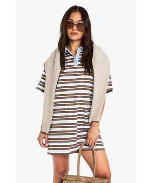 Petite-friendly rugby-style polo shirt dress with horizontal stripe pattern
        Contrast collar detail with button placket for a sporty touch
        Relaxed short sleeve design for effortless comfort
        Mini length silhouette perfect for the petite frame
        Cotton blend fabric offering breathability and easy wear
    
    This rugby-inspired polo shirt dress brings casual chic to your everyday wardrobe. The contrast collar adds a distinctive sporty element while the horizontal stripes create a playful, retro aesthetic. Style with trainers and oversized sunglasses for daytime outings, or dress it up with chunky boots and a crossbody bag for casual meetups with friends. The mini length is particularly flattering on petite frames, creating the illusion of longer legs. For cooler days, layer with a lightweight cardigan or denim jacket and add tights for extended seasonal wear. This versatile Boohoo piece transitions seamlessly from casual coffee dates to family gatherings, embodying that effortless style that's both comfortable and fashion-forward - perfect for the social butterfly who wants to stay on-trend without sacrificing comfort.