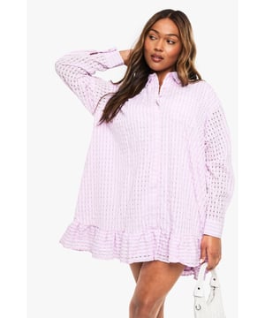 Textured fabric with intricate eyelet pattern throughout for added dimension
        Relaxed shirt dress silhouette with classic collar and button-down front
        Stylish drop hem design with feminine ruffle detail
        Long sleeves with buttoned cuffs for versatile styling options
        Plus size fit designed to flatter and provide comfortable wear
    
    This charming textured shirt dress combines casual comfort with effortless style. The airy eyelet fabric creates visual interest while the drop hem with ruffle detailing adds a playful, feminine touch to this wardrobe essential. Style with white trainers and a crossbody bag as seen on our model for daytime outings, or dress it up with strappy sandals for casual gatherings. The relaxed fit makes it perfect for family brunches, shopping trips with friends, or weekend getaways. Layer with a denim jacket when the temperature drops or wear it on its own during warmer months. The versatile button-down design allows you to customise your look - wear fully buttoned for a polished appearance or slightly undone for a more relaxed vibe. A true Boohoo staple that transitions seamlessly from day to evening casual events.