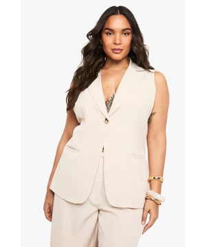 Sleeveless design with structured notched lapels for a sophisticated silhouette
        Single button fastening creates a flattering waistline definition
        Practical side pockets perfect for small essentials
        Versatile sleeveless cut ideal for layering or wearing alone
        Tailored fit with clean lines that complement curves beautifully
    
    This sleeveless blazer from Boohoo brings contemporary flair to your wardrobe staples. The clean-cut design offers endless styling possibilities-pair with the matching wide-leg trousers as seen on our model for a coordinated ensemble that works brilliantly for casual gatherings. For daytime outings, layer over a fitted tee with your favourite jeans and trainers. The sleeveless silhouette makes this piece particularly adaptable for transitional weather, allowing you to showcase statement jewellery while maintaining a polished appearance. For family gatherings, style with a silky camisole underneath and add metallic accessories for a touch of understated glamour. The versatile nature of this blazer ensures it will become a cornerstone in your capsule wardrobe, effortlessly taking you from casual brunches to smart-casual evening events with simple styling adjustments.