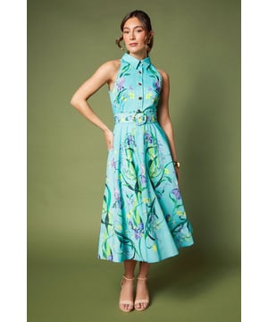 Sleeveless midi dress with classic collar and full button-through front design
        Striking floral print pattern adorns the cotton fabric throughout
        Matching fabric belt with circular buckle to define the waist
        A-line silhouette with pleated skirt for elegant movement
        Midi length falling approximately 123cm from shoulder to hem
    
    This sophisticated Coast midi dress combines timeless elegance with contemporary flair. The classic collar and button-through design create a refined silhouette, whilst the sleeveless cut ensures comfort for warm-weather occasions. The eye-catching floral print adds artistic charm to this graceful piece, making it perfect for summer weddings, garden parties or race day events. Style with delicate strappy heels as shown for a polished look, and add a fascinator for traditional race day sophistication. For cooler evenings, layer with a lightweight pashmina in a complementary tone. Complete your ensemble with subtle gold jewellery and a structured clutch to showcase the dress as your statement piece. This versatile dress transitions beautifully from daytime celebrations to evening receptions with a simple change of accessories.