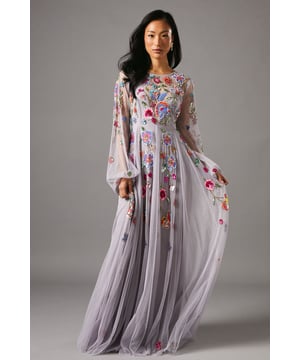 Exquisite hand-stitched embellishments featuring intricate floral detailing across the bodice and skirt
        Ethereal flowing chiffon maxi silhouette with graceful movement
        Dramatic bell sleeves creating an elegant, romantic profile
        Round neckline complementing the ornate embroidery work
        Delicate sheer overlay with carefully placed embellishments cascading down the skirt
    
    This enchanting Coast maxi dress showcases remarkable artistry with its hand-stitched embellishments that catch the light with subtle brilliance. The flowing chiffon fabric creates a graceful silhouette that moves beautifully with every step, whilst the statement bell sleeves add a touch of dramatic flair. Perfect for summer weddings or sophisticated garden parties, this dress commands attention without overwhelming. Style with minimal jewellery to let the intricate detailing take centre stage-perhaps just a pair of drop earrings and a simple bracelet. Complete your ensemble with strappy heeled sandals and a small clutch for an effortlessly refined look. The dress's timeless design ensures you'll stand out at any formal gathering, from race day events to evening receptions where elegance is paramount.
