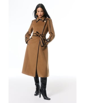 Fall '24: Allow our latest collection of autumn pieces to inspire you for the season ahead. Feel elevated no matter the weather in our midi length coat, made in high quality, thick wool, featuring a fit that flatters the figure and faux leather trims. Wear it over any outfit, whether heading out for dinner or to the office. Wool Blend Faux Leather Trim Belted Tailored Coat High Quality Wool Blend Fabric Flattering Fitted Bodice Straight Hanging Skirt Metallic Clasp Buttons at Collar and Cuffs High, Collared Neckline Belted Waistline Unique, Faux Leather TrimsShop this seasons belted coats and jackets or browse the full collection of coats and jackets now.