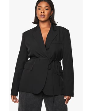 Structured shoulder pads for a bold silhouette
        Wrap-style design with a tie belt for a customisable fit
        Notched lapels adding a classic touch
        Long sleeves for versatile styling options
        Tailored fit to flatter curves
    
    Make a statement with this striking plus-size blazer, perfect for the fashion-forward woman who loves to stand out. The structured shoulder pads create a powerful silhouette, while the wrap-style design with a tie belt allows for a personalised fit that accentuates your curves. Pair it with wide-leg trousers and strappy heels for a chic evening ensemble, or dress it down with jeans and trainers for a smart-casual look. Ideal for a night out with friends or a trendy bar hopping adventure, this blazer effortlessly transitions from day to night. Layer it over a silky camisole for a touch of glamour, or wear it as a dress with statement jewellery for a bold, head-turning outfit. This versatile piece is a must-have addition to any fashion-lover's wardrobe, offering endless styling possibilities for the urban nightlife scene.