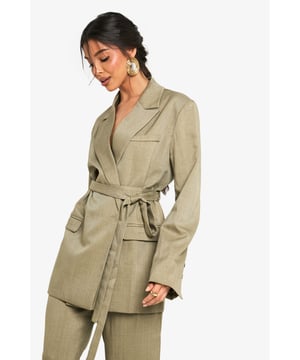 Oversized wrap blazer with a flattering wrap-front design and notched lapel collar
        Matching fabric belt to cinch the waist and create a defined silhouette
        Functional front pockets perfect for adding practicality to your look
        Long sleeves with subtle button detailing at the cuffs for added interest
        Relaxed fit with structured shoulders for a contemporary silhouette
    
    This versatile wrap blazer from Boohoo effortlessly bridges the gap between casual and smart dressing. The oversized silhouette offers a contemporary twist on traditional tailoring, whilst the belted waist allows you to customise the fit to your preference. Style with the matching wide-leg trousers as seen on our model for a coordinated suit that works brilliantly for family gatherings or casual workplace settings. For daytime outings, pair with straight-leg jeans and trainers for an effortlessly cool ensemble. The structured shoulders and clean lines maintain a polished appearance even when dressed down. Complete your look with statement earrings similar to those worn by our model to add a touch of personality. This blazer is a true wardrobe hero that can be styled countless ways for various casual occasions throughout the seasons.