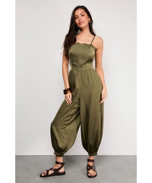 Delicate lace trim along the neckline adds a feminine touch to this satin jumpsuit
        Adjustable strappy design ensures a comfortable, personalised fit
        Elasticated cuffs create a distinctive balloon silhouette for the legs
        Relaxed fit through the body offers effortless movement and comfort
        Petite sizing ensures the perfect proportions for smaller frames
    
    This Warehouse satin jumpsuit combines casual comfort with sophisticated style. The lustrous fabric catches the light beautifully whilst the elasticated cuffs create a fashionable balloon silhouette that's both on-trend and flattering. Perfect for daytime gatherings, style with flat strappy sandals and wooden bangles for a relaxed garden party or family lunch. For cooler evenings, layer with an oversized denim jacket and switch to ankle boots. The versatile design transitions seamlessly from casual brunches to evening drinks - simply add statement earrings and a clutch bag to transform your look. The adjustable straps allow you to customise the fit, making this jumpsuit a wardrobe essential that works hard for your everyday style.